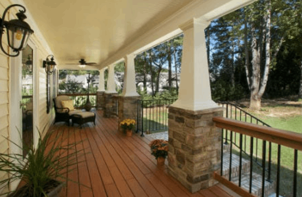 AFTER installation of stone front porch of beige shingled home side view