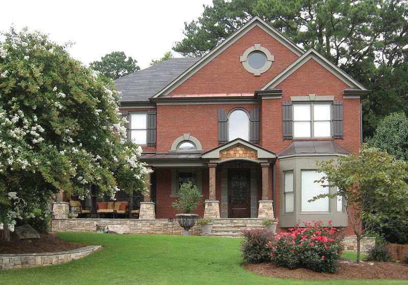 AFTER installation of front porch with big tree in front left