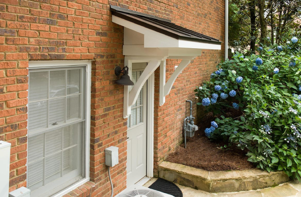 AFTER side back door portico on brick home with white door