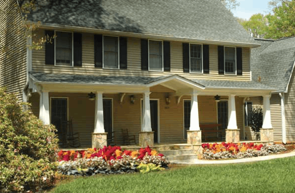 AFTER front porch on craftsman tudor home with white columns on stone 2