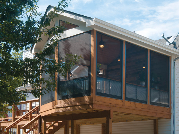 screened porch next to deck with wood wall and wood ceiling