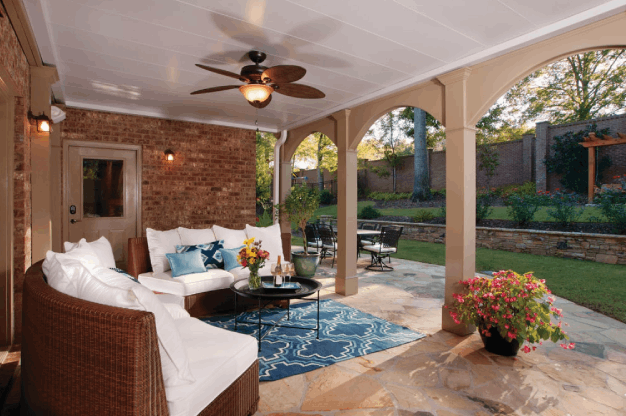 under deck open porch with white cushions and blue rug