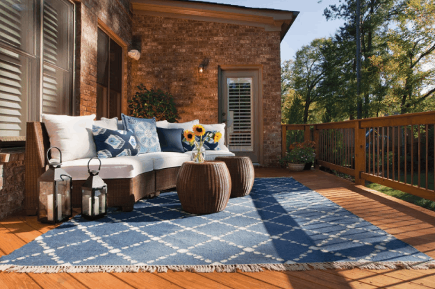 above under deck open porch with white cushions and blue rug installed by top deck builders in Atlanta