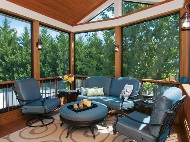 screened porch with wood wall and wood ceiling with furniture