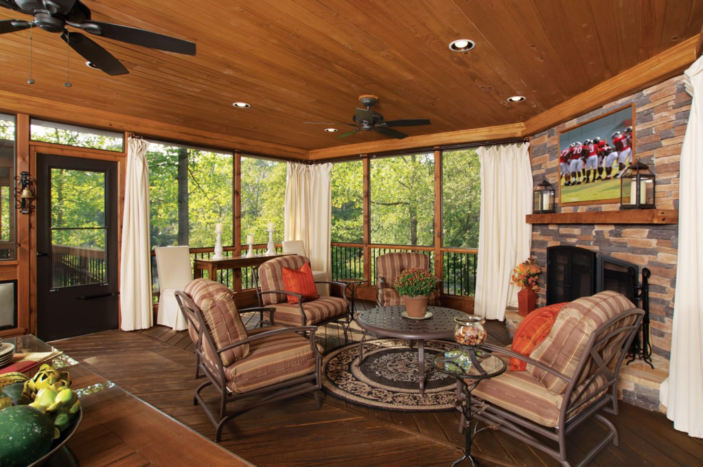 screened porch with table and chairs wood with stone fireplace 2