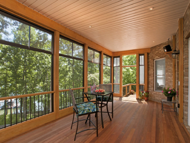 wooden open porch close up of table and chairs facing woods