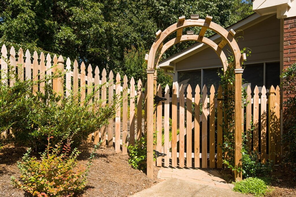 Atlanta picket fence contractors build classic wooden picket fence with arbor