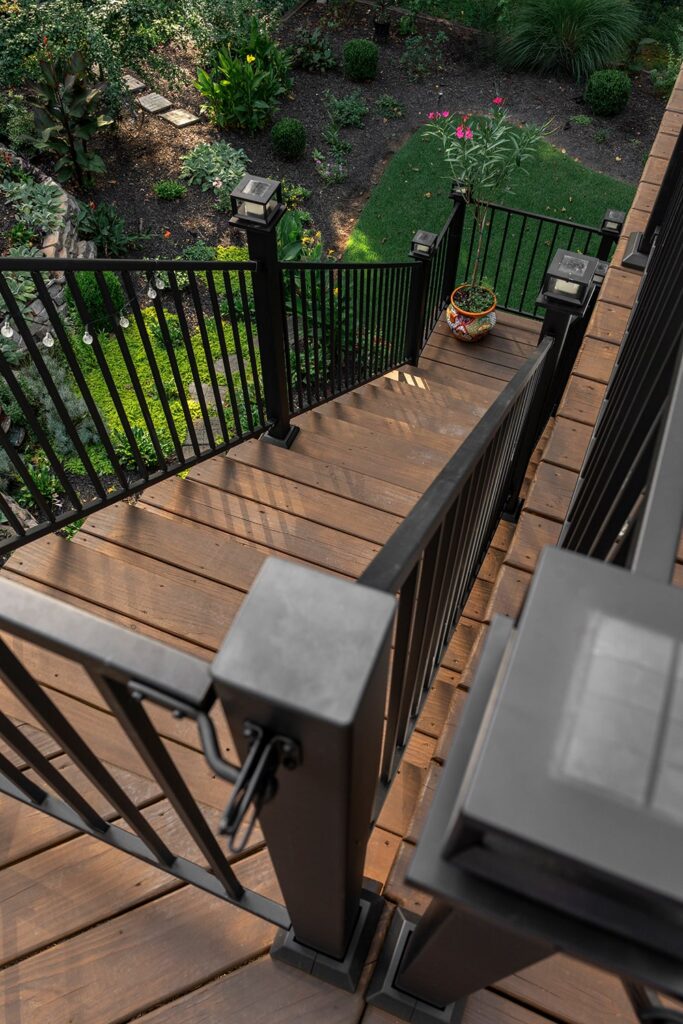 close up view of exterior stairs and metal railing from deck