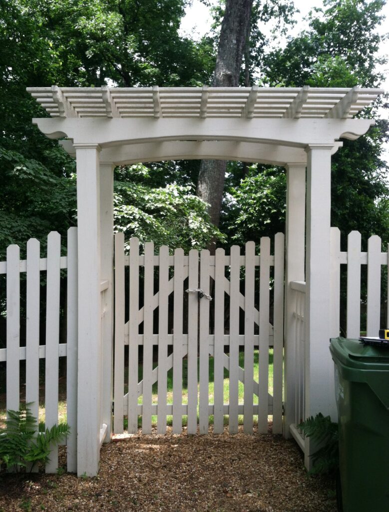 white picket fence and gate arbor