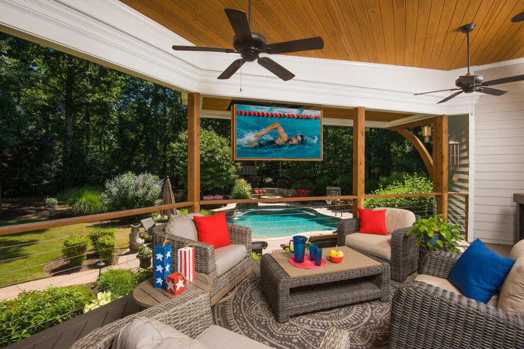 open porch with cable railing overlooking swimming pool