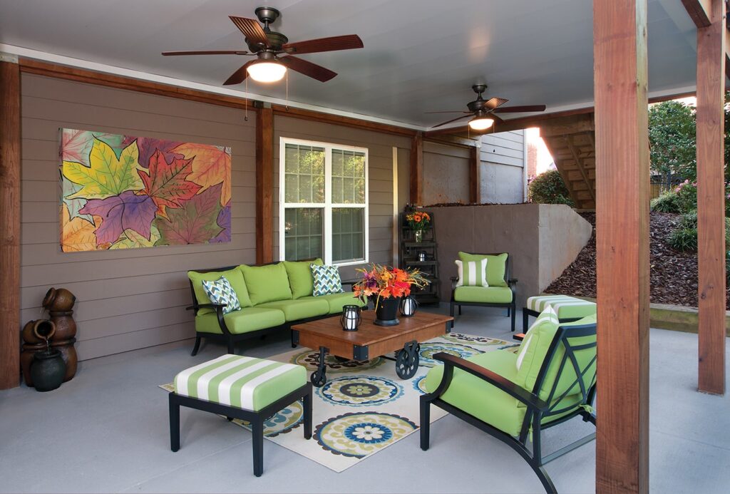 patio under wooden deck with green furniture