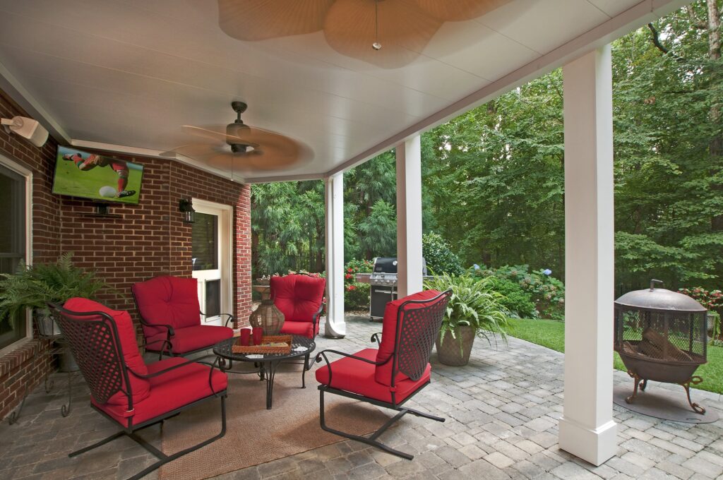 Under deck patio to grill with red furniture