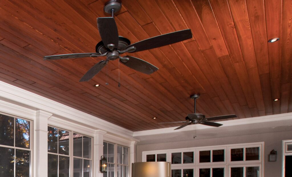 back porch white paneling with wooden ceiling with fan