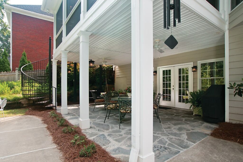 under deck patio remodel with white beams and stone floor