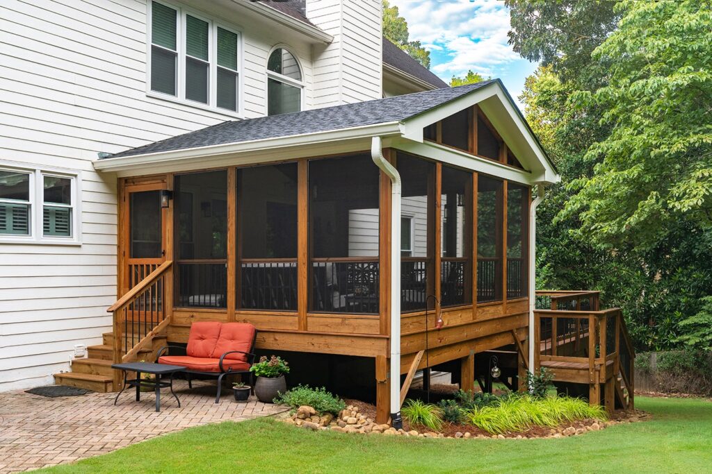 Milton Screened Porch by Atlanta Decking with with pressure-treated lumber and aluminum banisters