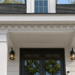 White flat-roof portico with square columns on a Cape Cod home in East Cobb, Georgia